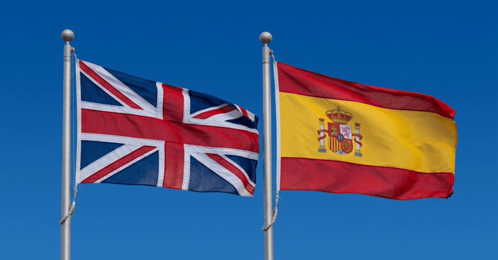 United Kingdom and Spanish flags flying on adjacent poles
